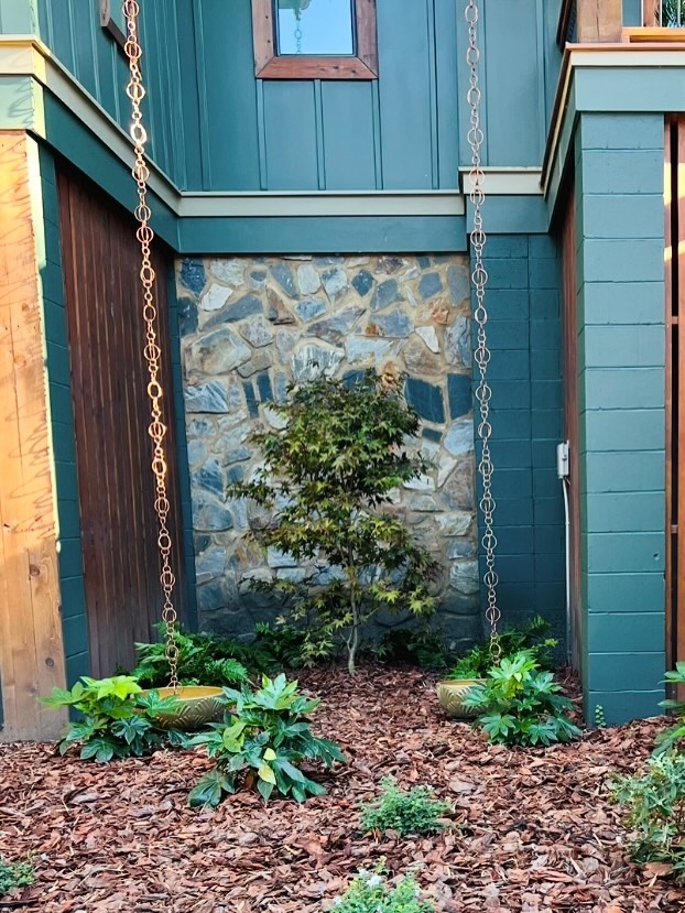 Japanese maple courtyard with cast bowls, ferns, and rain chains — Mount Pleasant.
